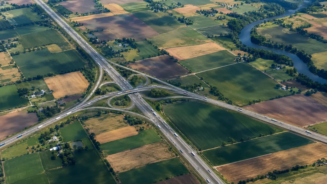 Vista aérea a gran altura de autopistas interestatales cruzando un mosaico de campos de cultivo